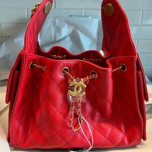 CHANEL Red Quilted Drawstring Shoulder Bag with Gold CC Hardware